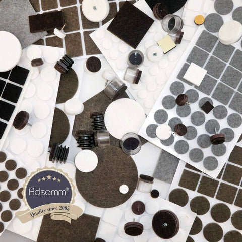 Pro Grade Self Adhesive Felt Pads And Furniture Glides assortment of various sizes and shapes, black and white, for protecting floors.