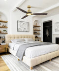 56" Soft Brass Chandelier Ceiling Fan,2 Downrods Fandelier with Remote above a stylish bedroom with solid wood blades.