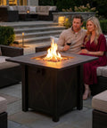 30 Inch Propane Fire Pit Table With Premium Ceramic Top, 50000 BTU Gas Firepit, Includes Lid And Lava Rocks, Doubles As A Stylish Outdoor Coffee Table For Patio, Garden Or Yard, Great For Dining, Parties And Cozy Evenings in a patio setting
