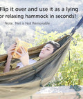 Person reading in Portable Camping Hammock With Net For Single Or Double Use at outdoor setting.