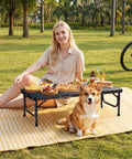Person sitting on a picnic blanket with snacks on a Three Foot Low Folding Picnic Table With Thick Aluminum Build, 10.3 Inch High.