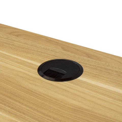 Round Black Plastic Desk Grommet With Brush Opening And Removable Lid Fits 3 15 Inch Cutouts installed on wooden desk.