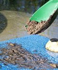 Green Prospector's Scoop 12.5 Inch Heavy Duty Plastic Dig Tool in action, scooping soil for metal detecting and gardening.