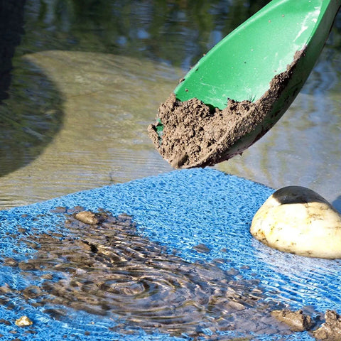 Green Prospector's Scoop 12.5 Inch Heavy Duty Plastic Dig Tool in action, scooping soil for metal detecting and gardening.