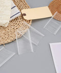2 Inch Tagging Gun Fasteners 5000 Pack Pro Grade Heavy Duty Clothing Tag Barbs shown on woven mat with fabric