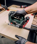 Heavy Duty Knockout 18V Brushless Cordless Jigsaw cutting through wood on a worktable, showcasing ergonomic grip and precision.