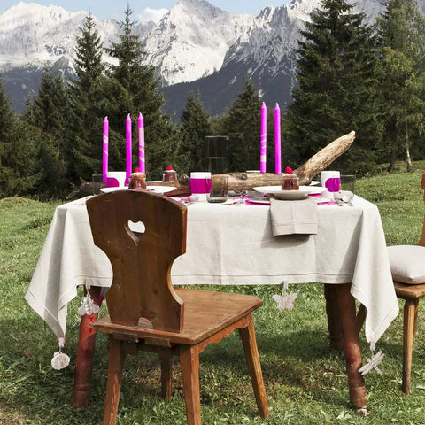 Outdoor picnic table with 4 Pack Tablecloth Weights With Metal Clips Clamps For Outdoor Parties And Picnics, Cast Iron Weights In Butterfly Bee Dragonfly And Ladybug Shapes, Keeps Table Cover Locked Down In The Wind, Ideal For Indoor And Outdoor Use, decorated with pink candles.