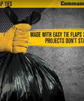 Gloved hand holding 55 Gallon 3 Mil Heavy Duty Contractor Trash Bags with flap ties, ideal for construction sites and outdoor projects.