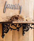 Rock Solid Decorative Shelf Brackets Wrought Iron Corbels 15.5 X 7.2 In Antique Black holding dried flowers on wooden shelf.