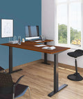 Level Up Your Remote Setup With This Hella Reliable Triple Motor Electric L Shaped Corner Standing Desk Featuring Smooth Programmable Height Presets Snap Together Black Steel Frame And Solid Teak Desktop For Non Stop Productivity, angled view in home office.
