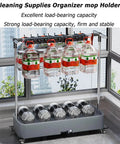 Heavy Duty Floor Mounted Mop Rack And Broom Holder With Stainless Steel Frame And Thick ABS Tray shown with cleaning supplies