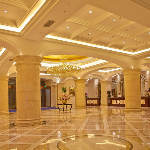 Elegant lobby with ornate columns and chandelier, featuring Commercial Grade Led Par20 Flood Light Bulbs 60W Equivalent 600 Lumens