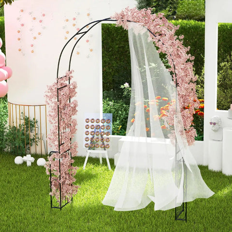 7.9 Ft Metal Garden Arch Trellis For Climbing Plants Like Roses And Clematis in black with pink flowers and draped fabric outdoors