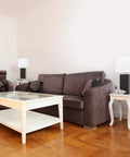 Leather Wrapped Table Lamps Set Of 2 in gray finish with white fabric shades on side tables in a modern living room.