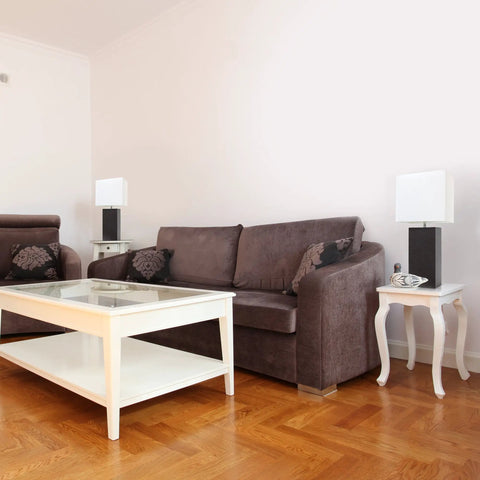 Leather Wrapped Table Lamps Set Of 2 in gray finish with white fabric shades on side tables in a modern living room.