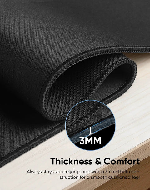 Close-up of Oversized Gaming Mouse Pad With Durable Stitched Edges And Non Slip Rubber Base For Home Office And Gaming Setups 31.5 Inches By 11.8 Inches Desk Mat Keyboard Mat highlighting 3mm thickness.