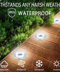 12 LED Solar Ground Lights Waterproof In Ground Disk Pathway Lights For Yard Garden Lawn Patio Walkway Pool 8 Pack White Outdoor Disk Lamps for weatherproof illumination on a wooden deck at night with greenery