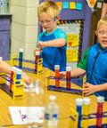 Children using Large Plastic Test Tubes and Rack Set With Six Bottles Kid Friendly Science Experiments Durable Clear Lab Kit For Classroom Fun and Home STEM Projects For Hands On Learning in a classroom.