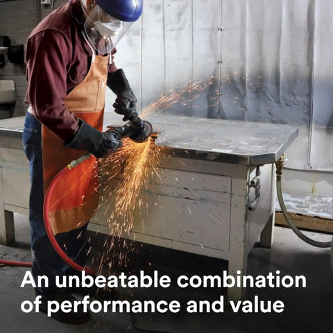 Worker using Cubitron II Fiber Disc 982C for heavy grinding and weld removal, sparks flying, safety gear on, in workshop.
