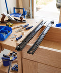 Heavy Duty Soft Close Bottom Mount Drawer Slides For Cabinets on a woodworking workbench with tools and materials.