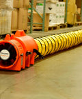 Beefy Industrial Com-Pax-Ial Blower Kit with canister and 8 inch by 25 foot duct, orange polyethylene housing, 831 CFM shown in warehouse.