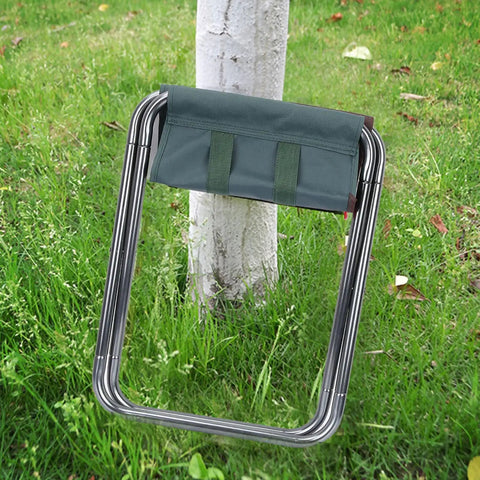 Portable Oxford Cloth Folding Stool With Lightweight Aluminum Frame For Outdoor Camping And Picnics Easy Foldable Chair For Fishing And BBQs Compact Sturdy And Comfortable Dark Green Seat beside a tree