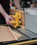 Person using GRR-RIPPER Advanced 3D Pushblock With Handle Bridge Kit on wood, showcasing safety and precision in woodworking.