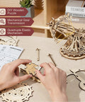 Hands On 3D Wooden Ballista Launcher Kit For Adults DIY Puzzle Model Toy And STEM Project That Feels Like Real Mechanical Fun Built For Solo Or Team Play Mindful Crafting And Endless Replay Value, wooden ballista assembled on table