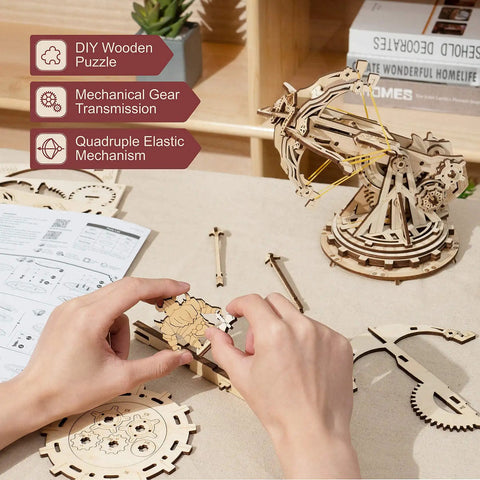 Hands On 3D Wooden Ballista Launcher Kit For Adults DIY Puzzle Model Toy And STEM Project That Feels Like Real Mechanical Fun Built For Solo Or Team Play Mindful Crafting And Endless Replay Value, wooden ballista assembled on table
