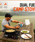 Man using Dual Fuel Portable Camping Stove 3000W with butane and propane on picnic table for outdoor cooking.