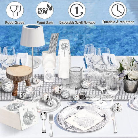 Disco Ball Party Supplies Kit 121 Pcs Silver Disposable Plates Napkins Cups Mini Disco Balls And Table Runner on a poolside table.
