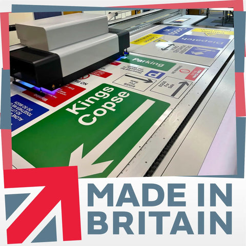 Printing machine producing various signs with text, including green 'Kings Copse' direction sign.