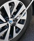 3/8-Inch Drive Ratcheting Breaker Bar Adapter in use on car wheel, reversible mechanism with switch collar in tight spot
