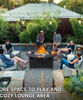 Beefy 40 Inch Fire Pit Surround Tabletop with people gathered, showing powder-coated steel design in an outdoor setting