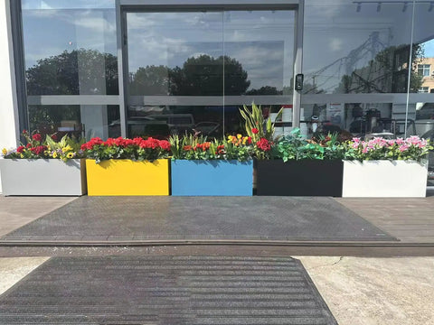 Multi-colored rectangular planter boxes with flowers on a patio, including 40 Inch Long Metal Rectangular Planter Box For Outdoor Patio Porch Black Modern Design Built To Last No Tool Needed Quick Snap In Planter For Plants Flowers Garden Heavy Duty Outdoor Box For Deck Balcony.