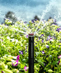 MP Rotator Sprinkler Nozzle With Adjustable 90 To 210 Degree Arc, 8 To 15 Foot Radius in garden, spraying water on flowers