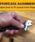 Hand using Knuckle Bender With Built-In Hinge Pin Remover, Adjustable Door Hinge Tool for quick sagging door fixes on wooden surface