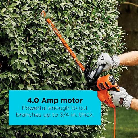 Person using 22 Inch Electric Hedge Trimmer With Dual Action Blades And Full Wraparound Handle, 4 Amp Corded Power on shrubs