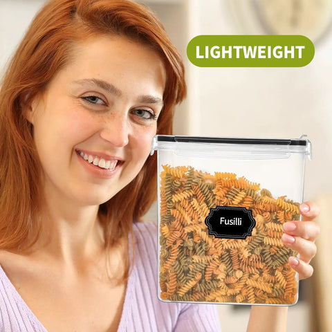 Smiling woman holding a Four Pack Cereal Storage Container With Airtight Lid and Pour Spout, 4L, BPA Free, with pasta inside