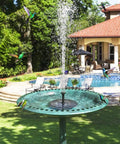 Upgraded Mini Solar Powered Fountain Pump for bird baths with solar panel in a garden setting by a pool with hummingbirds