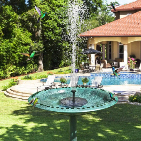 Upgraded Mini Solar Powered Fountain Pump for bird baths with solar panel in a garden setting by a pool with hummingbirds
