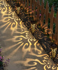 Solar Powered Fire Totem Style Outdoor Garden Lights Six Pack Waterproof Conical Stakes illuminating a garden pathway