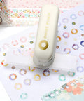 Killer Precision Donut Punch For Washi Tape And Paper Crafting Tool For Ring Binder Hole Repair with patterned washi tape and donut stickers.