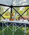 Interior of Pop Up Gazebo Screen House Tent 11.5 Ft for 8 to 10 People, showing table and chairs in outdoor backyard setting.