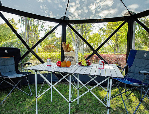 Interior of Pop Up Gazebo Screen House Tent 11.5 Ft for 8 to 10 People, showing table and chairs in outdoor backyard setting.