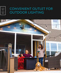 Family on porch under Carter 2-Light Outdoor Wall Lantern With Built-In GFCI Outlet In Aged Bronze, strung lights visible