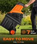 Person moving Powerful Electric Wood Chipper Shredder For Quick Yard Cleanup With 1800W Power on wheels in garden