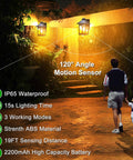 Solar Powered Outdoor Wall Light With Three Modes Dusk To Dawn Motion Sensor illuminating a walkway, IP65 waterproof.