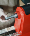 BMWOOD 4-prong spur drive center with 2MT shank and 1-inch diameter, held by hand beside a red wood lathe.