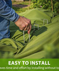 Person installing Heavy Duty 12 Inch Landscape Staples U Shaped Ground Stakes Galvanized 8 Gauge Steel for Outdoor Decor
